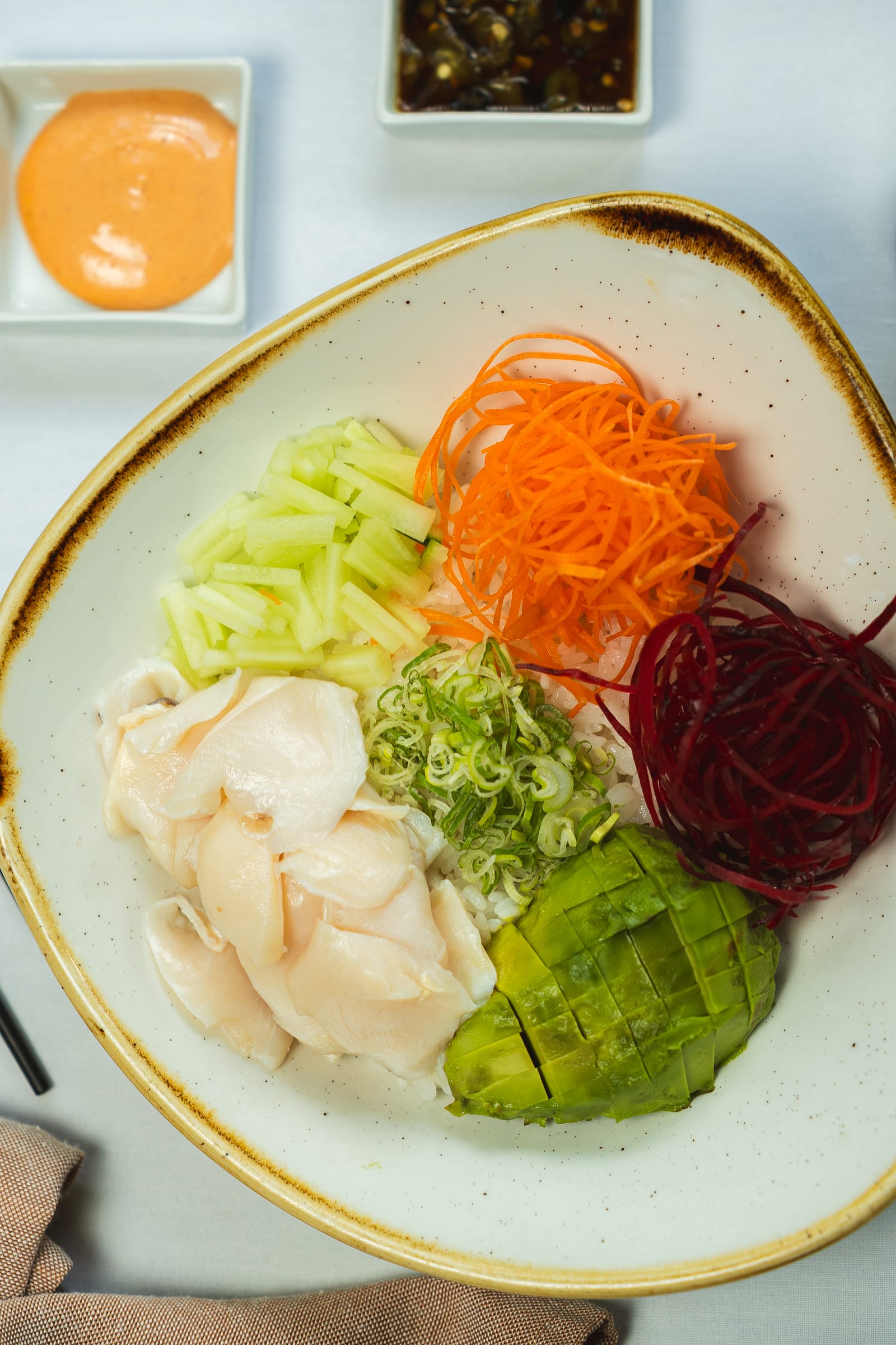 Bowl de láminas de pescado blanco fresco con aguacate y verduras